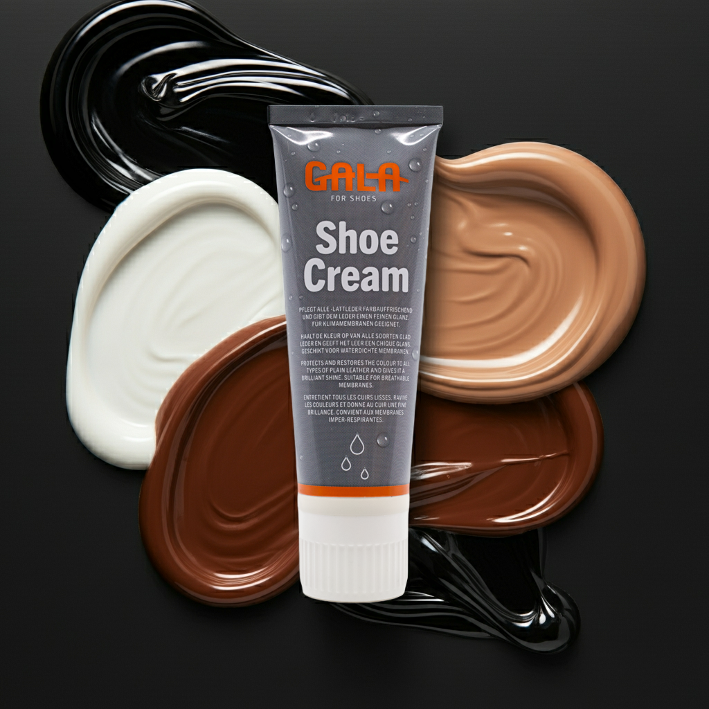 CasaBellissimo GALA for Shoes Schuhcreme 75 ml Tube auf dunkelgrauem Hintergrund mit farbigen Schuhcremeklecksen in schwarz, weiß, hellbraun, dunkelbraun, schlamm, nevada